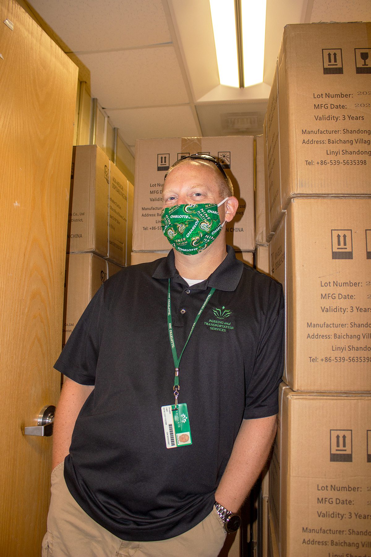 Doug Lape poses with a room full of disposable masks at the IMT Logistics Center.