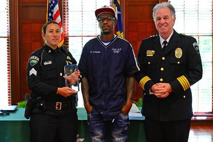 Sgt. Stephanie Klein (left) receives the David A. Coleman Sr. Excellence in Leadership Award from David Coleman Jr. (center) and Chief Jeff Baker.