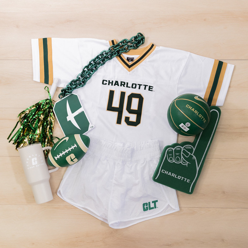 Flat lay or a Charlotte Jersey, shorts and merchandise.