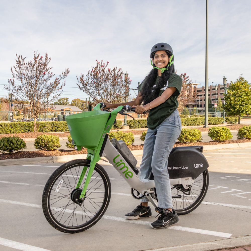 Student on a Lime e-bicycle.